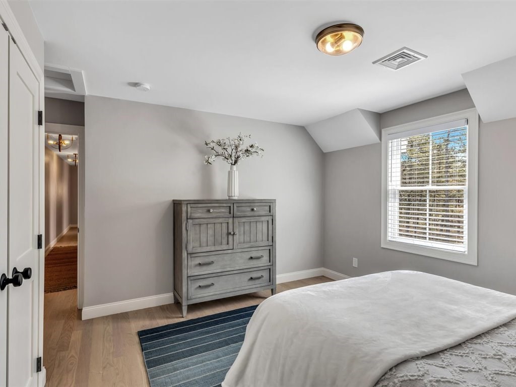 9 West Way Mashpee, MA 02649 - Photo 42 of 42 a bedroom with a bed and a chandelier