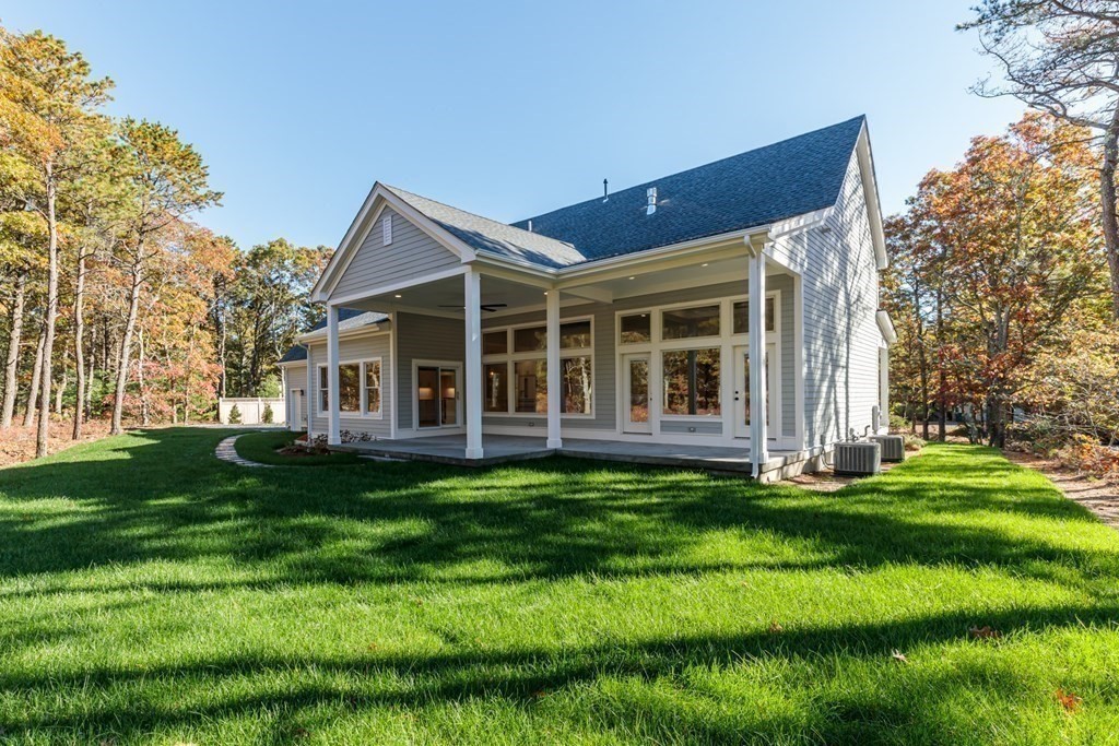 9 West Way Mashpee, MA 02649 - Photo 7 of 42 a view of a house with a yard and sitting area