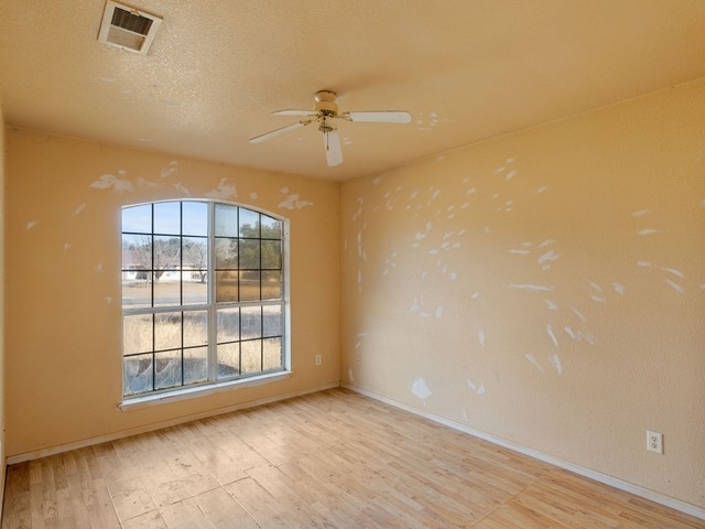 121 Meadowlake Lane Kempner, TX 76539 - Photo 11 of 14 an empty room with windows and fan
