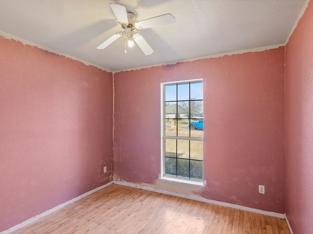 121 Meadowlake Lane Kempner, TX 76539 - Photo 12 of 14 an empty room with windows and fan