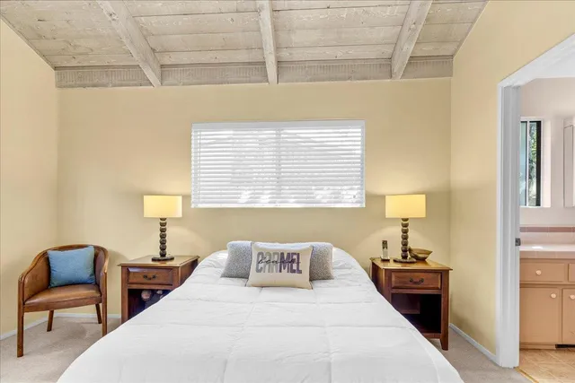 a bathroom with a sink and mirror with toilet
