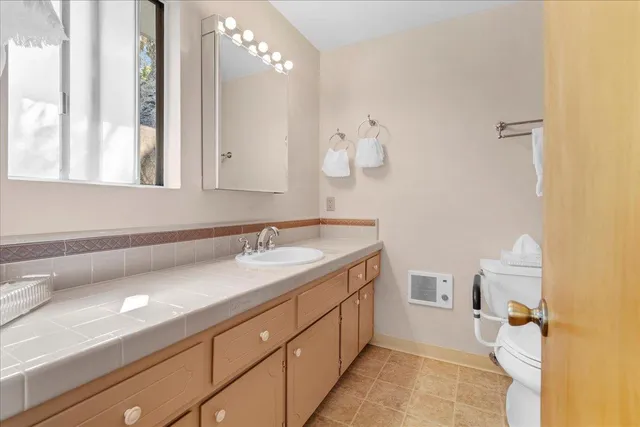a bathroom with a sink vanity and a mirror