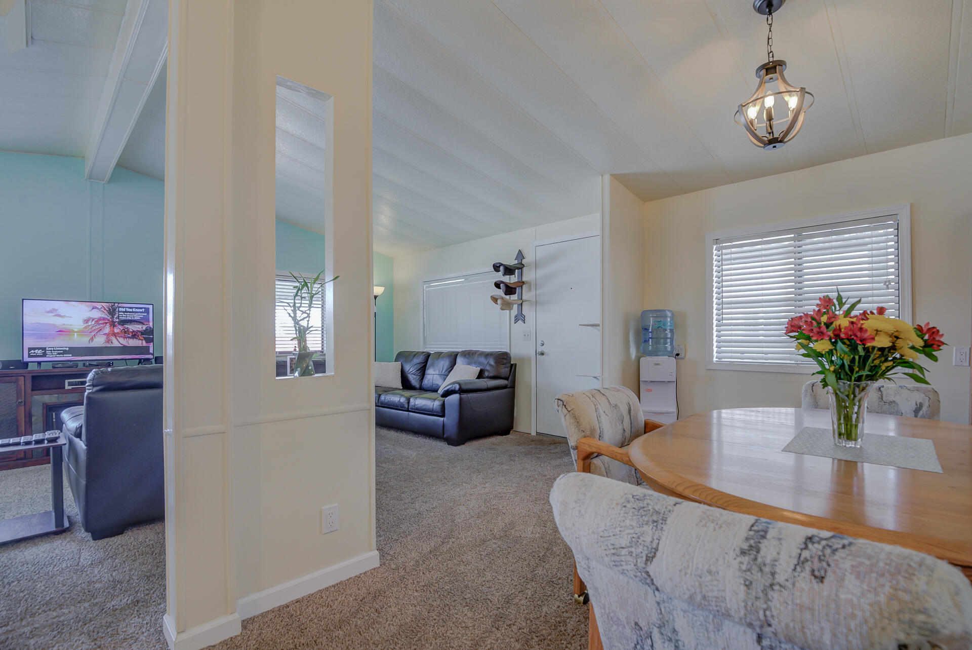 2873 Arcade Redding Ca, Unit STARLITE Redding, CA 96002 - Photo 12 of 32 a living room with furniture potted plant and a chandelier