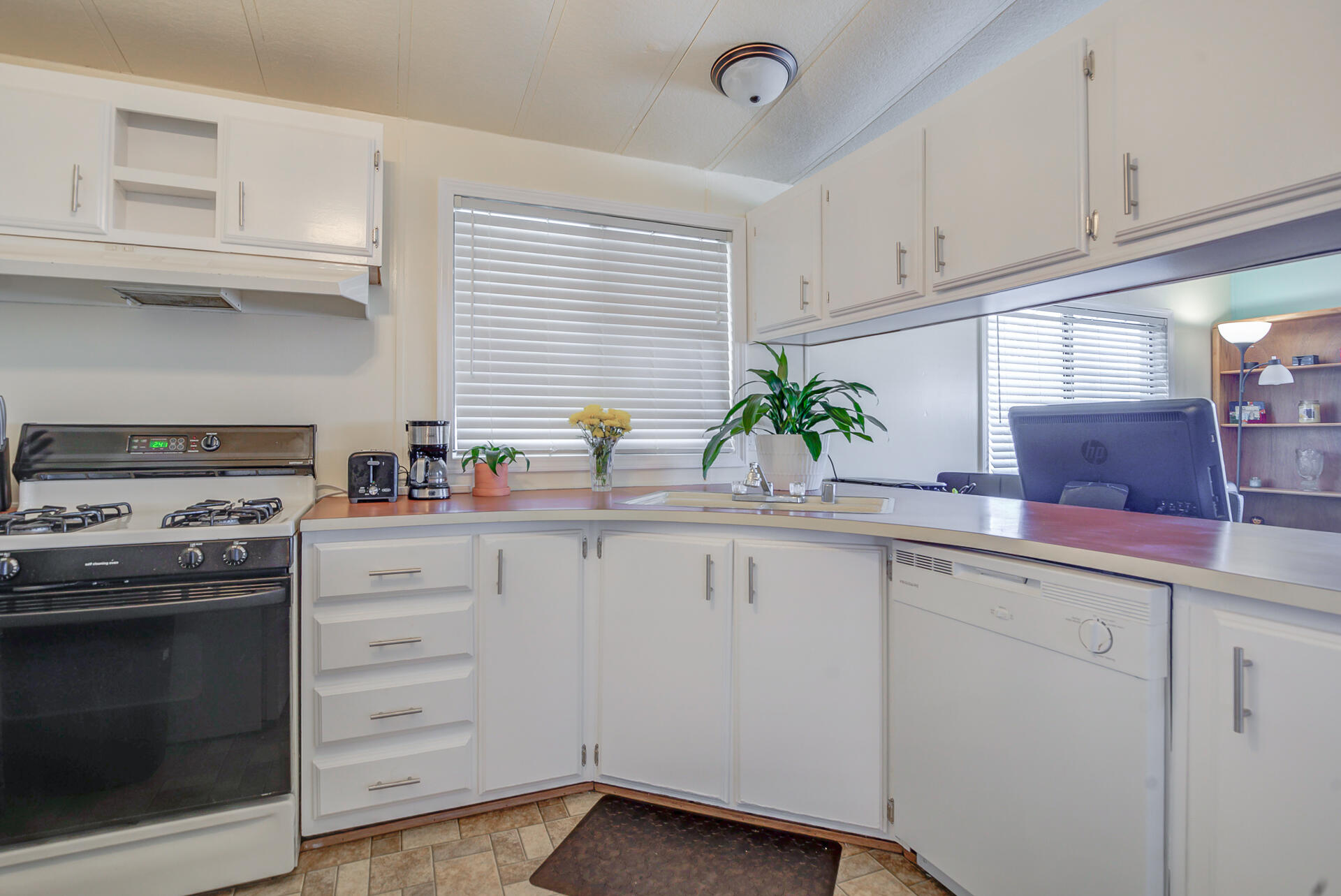 2873 Arcade Redding Ca, Unit STARLITE Redding, CA 96002 - Photo 16 of 32 a kitchen with granite countertop a sink stainless steel appliances and cabinets