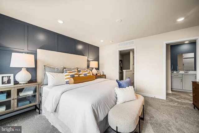 a bedroom with a bed and lamp