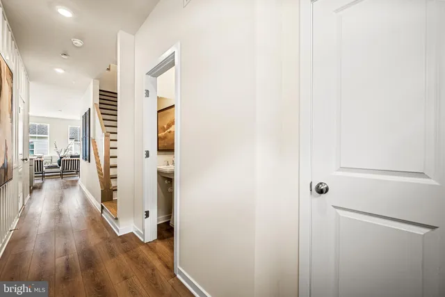 a view of a hallway view with wooden floor and staircase