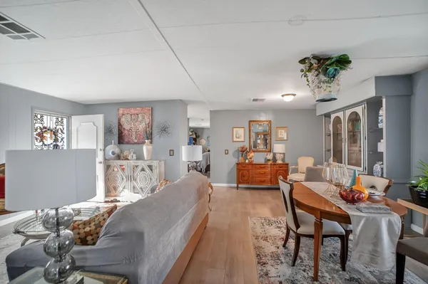 a living room with furniture and a chandelier