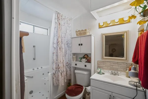 a bathroom with a sink and a mirror with toilet