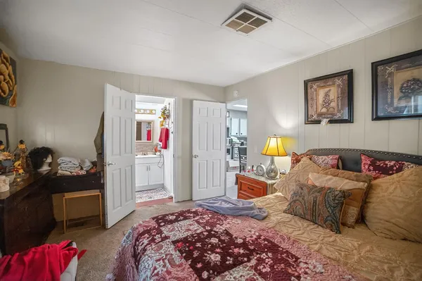 a bedroom with a bed and dresser