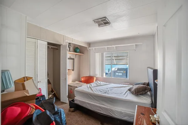 a bedroom with a bed and window