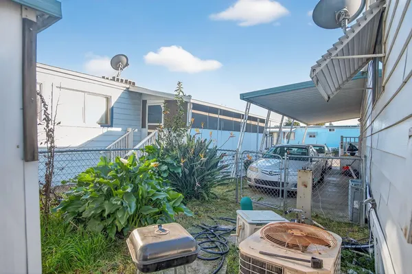 a view of a backyard with plants and outdoor seating