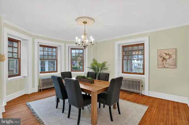 a kitchen with stainless steel appliances granite countertop a stove a sink dishwasher and a dining table with wooden floor