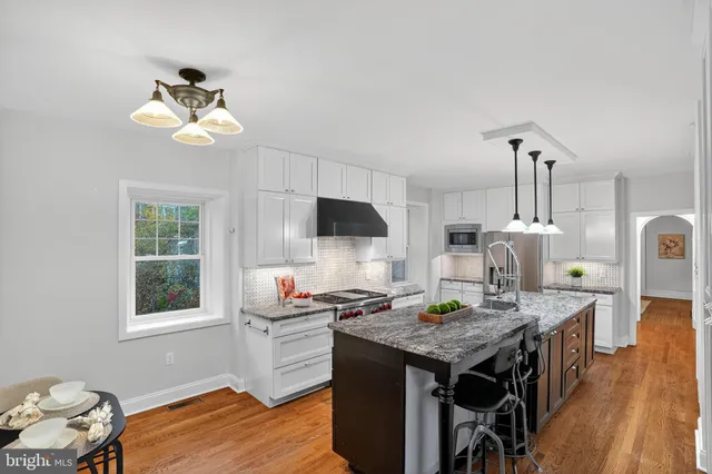 a workspace with wooden floor and a potted plant
