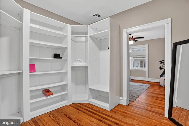 a spacious bathroom with a granite countertop tub a double vanity sink and a mirror