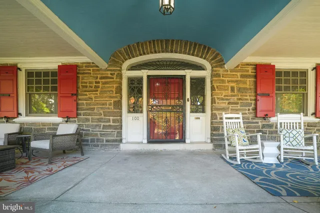 a view of front door of house with outdoor seating