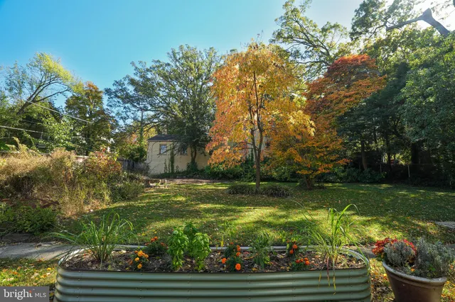 a backyard of a house with table and chairs