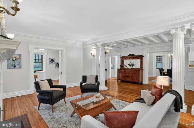 a view of a dining room with furniture wooden floor and a chandelier