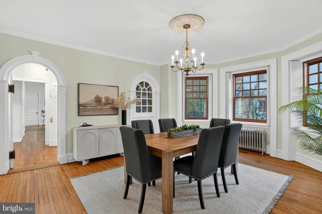 a view of a dining room with furniture wooden floor and a chandelier