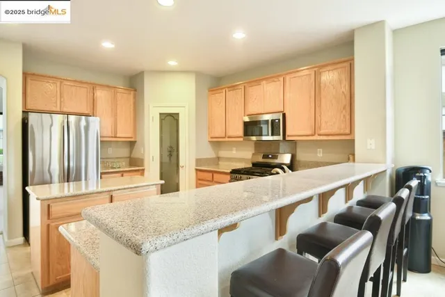 a kitchen with stainless steel appliances granite countertop a stove and a microwave