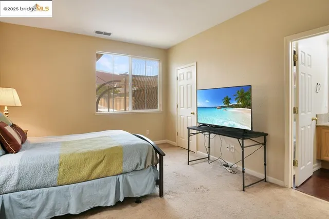 a bedroom with a bed and window