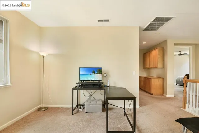 a view of hallway with furniture and a window