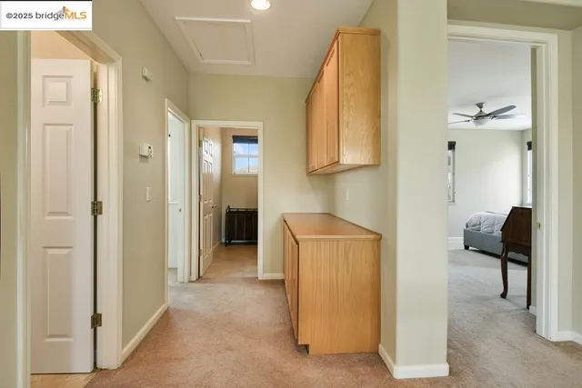 a bathroom with a granite countertop sink a toilet a mirror a vanity and shower