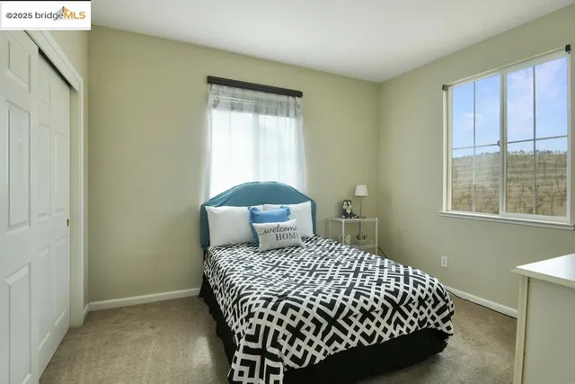 a bedroom with a bed and a window