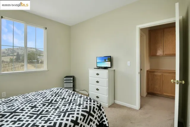 a spacious bedroom with a bed and window