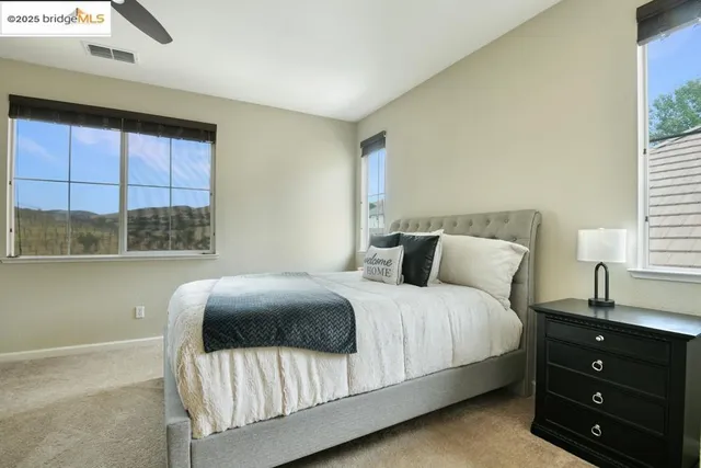 a spacious bathroom with a tub sink and mirror