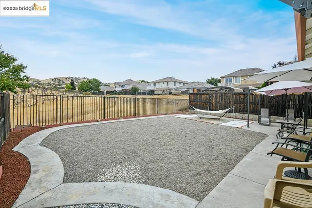 a view of house with patio and outdoor seating