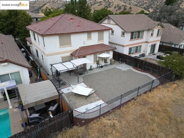 an aerial view of house with yard and parking space