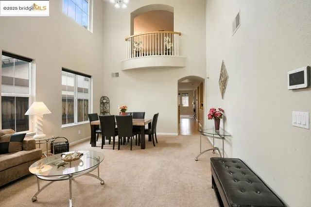 a living room with furniture a rug and white walls