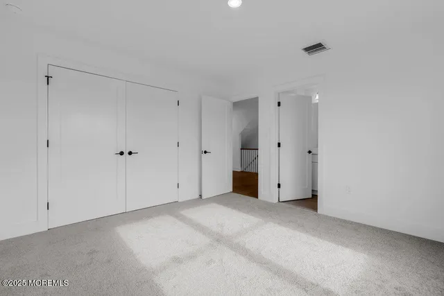 an empty room with wooden floor and a fireplace