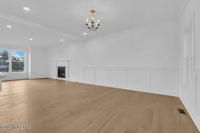 a large kitchen with stainless steel appliances granite countertop a sink a stove and a refrigerator