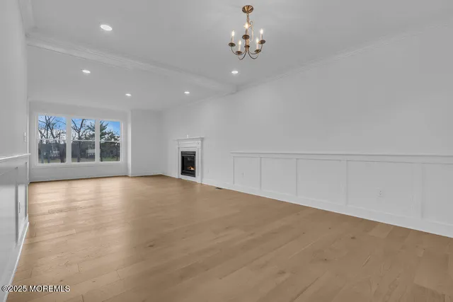 a view of a kitchen with kitchen island a sink stainless steel appliances and cabinets