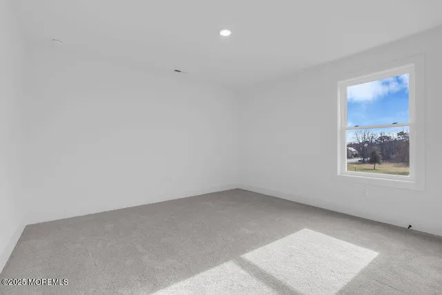 an aerial view of residential houses with outdoor space and trees