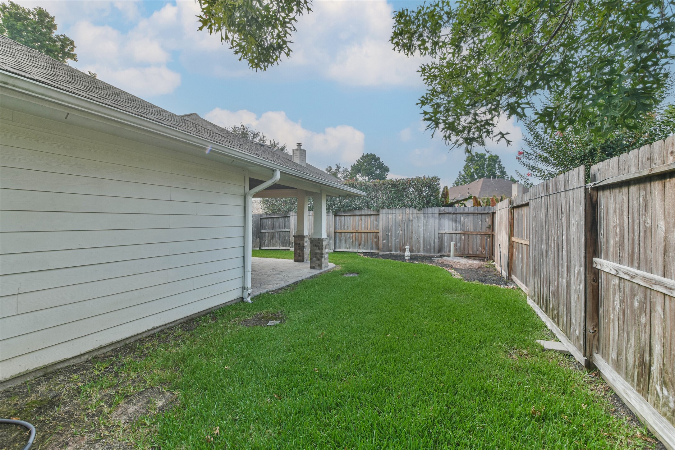 20942 Wind Field Lane Spring, TX 77379 - Photo 44 of 46 a view of a backyard with plants and large trees