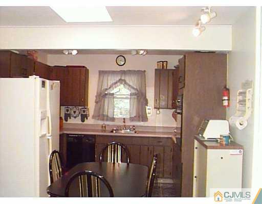 41 MacAfee Road Somerset, NJ 08873 - Photo 4 of 8 a kitchen with a refrigerator and a stove