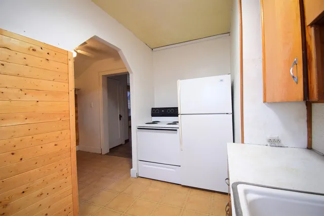 a kitchen with a refrigerator and a stove