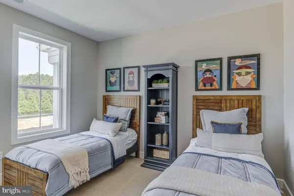 a bedroom with a bed and painting on the wall