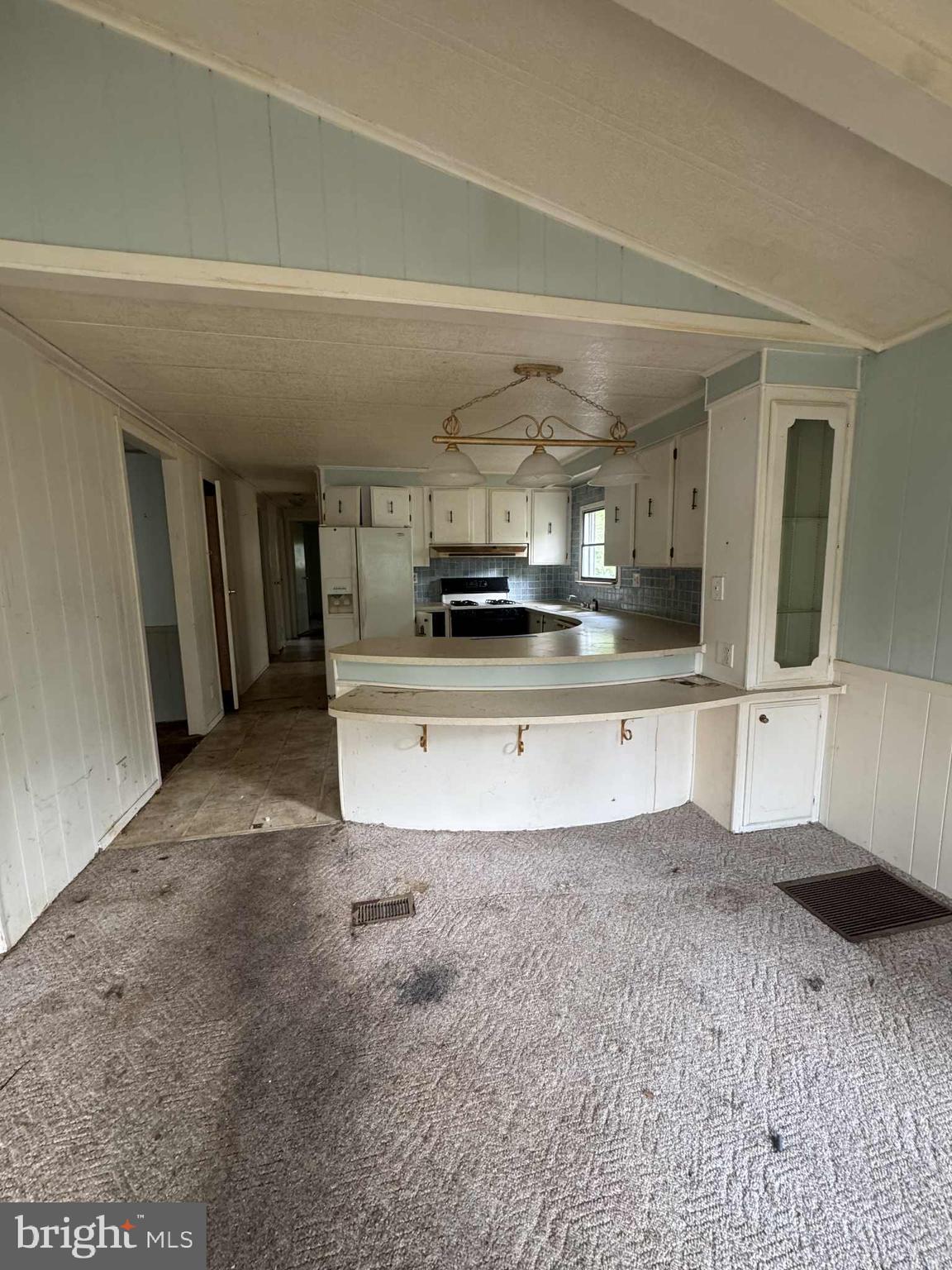 31061 Vacation Road Millsboro, DE 19966 - Photo 2 of 12 a large kitchen with stainless steel appliances kitchen island granite countertop a sink and cabinets