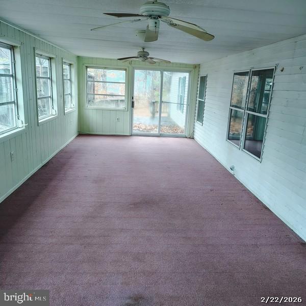 31061 Vacation Road Millsboro, DE 19966 - Photo 5 of 12 an empty room with windows and chandelier
