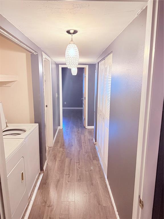 6519 West Newberry Road, Unit 211 Gainesville, FL 32605 - Photo 13 of 20 a view of a hallway with wooden floor and staircase