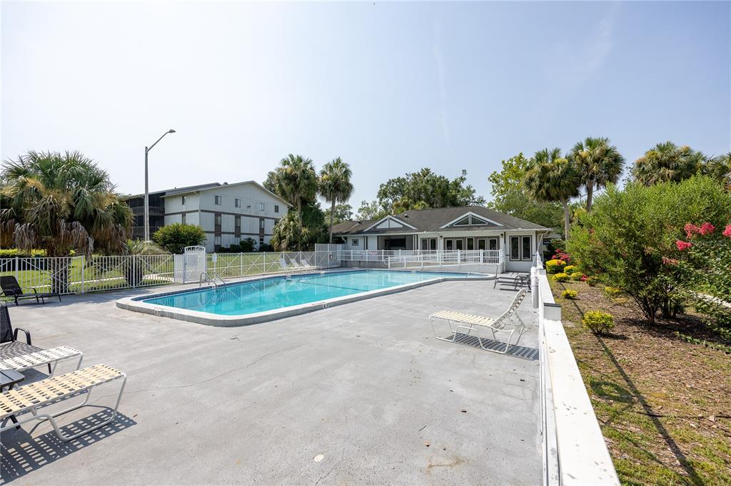 6519 West Newberry Road, Unit 211 Gainesville, FL 32605 - Photo 15 of 20 a view of a swimming pool with a yard