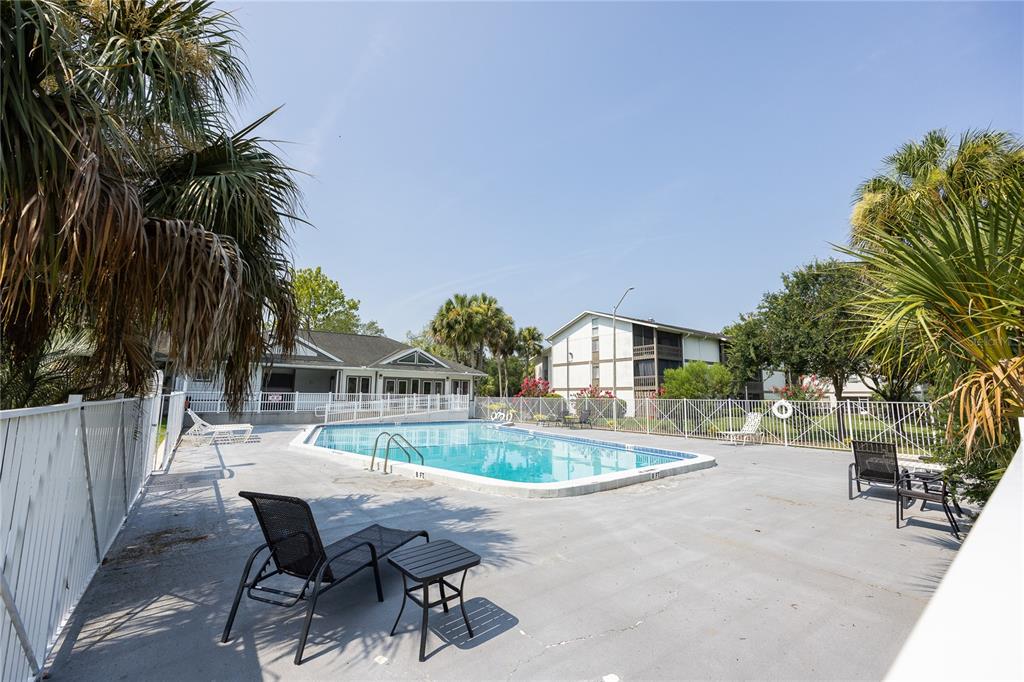 6519 West Newberry Road, Unit 211 Gainesville, FL 32605 - Photo 16 of 20 a view of a house with a swimming pool and sitting area