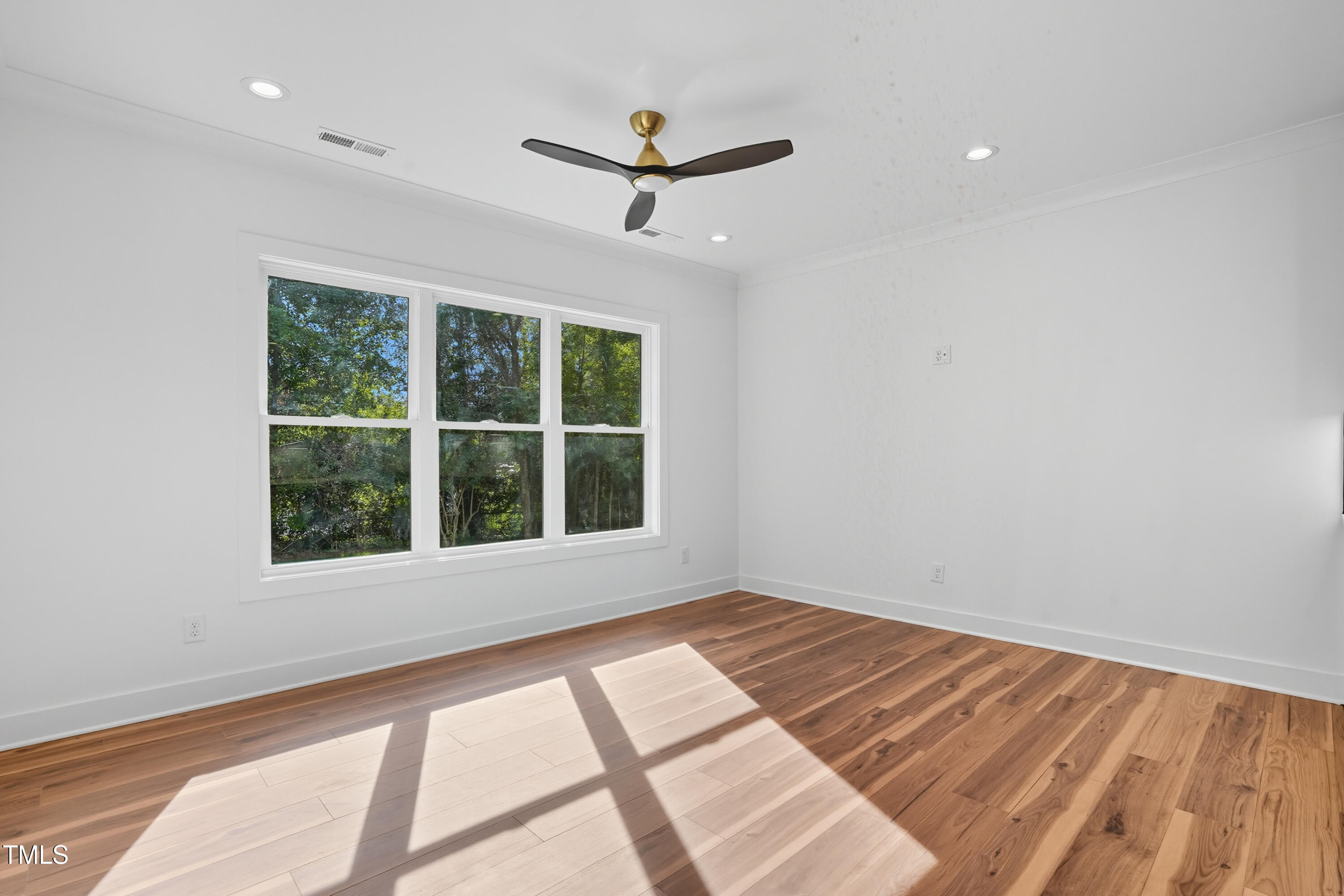304 North King Charles Road, Unit 102 Raleigh, NC 27610 - Photo 11 of 30 wooden floor in an empty room with a window