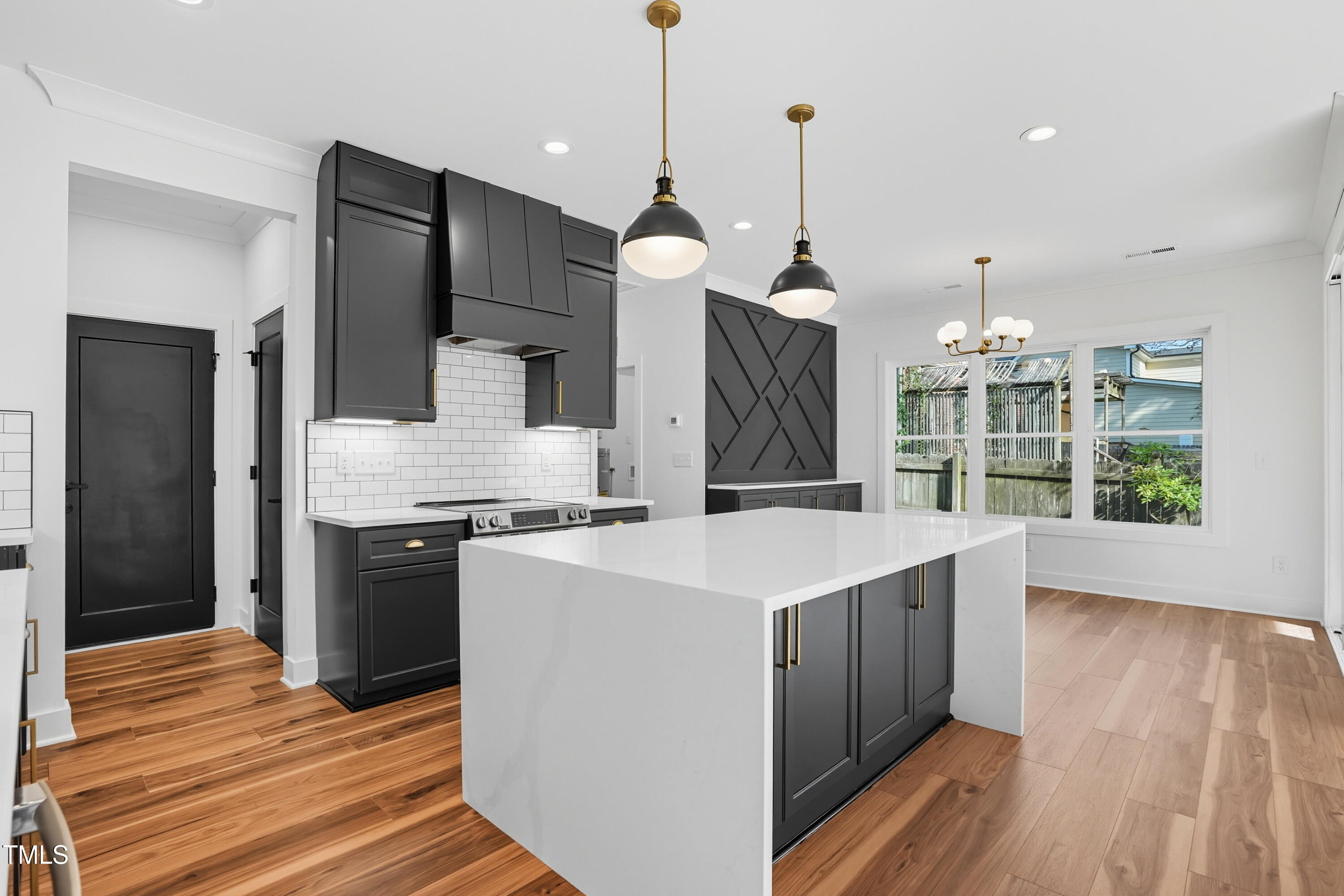 304 North King Charles Road, Unit 102 Raleigh, NC 27610 - Photo 16 of 30 a kitchen with kitchen island a counter space a sink appliances and cabinets