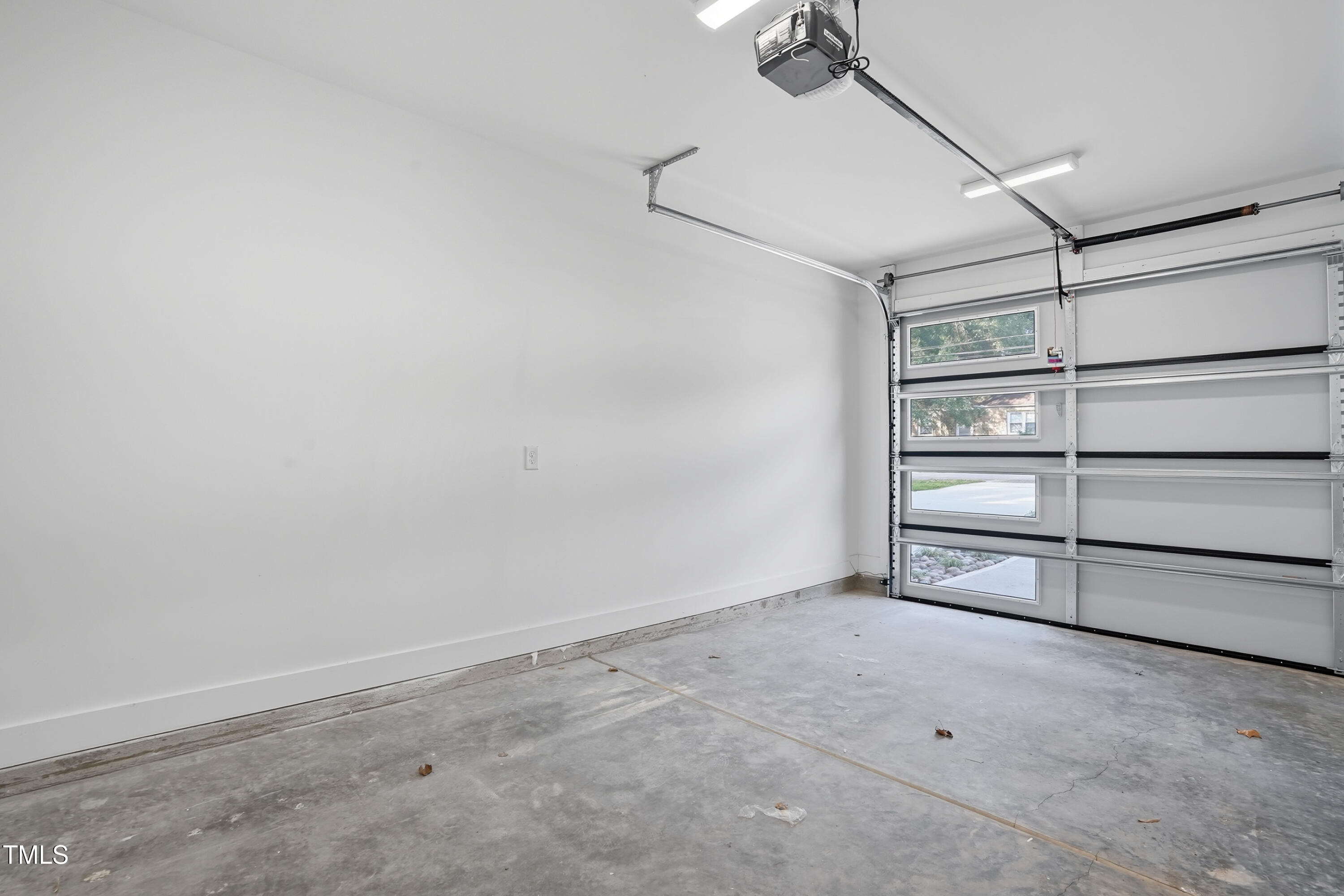 304 North King Charles Road, Unit 102 Raleigh, NC 27610 - Photo 19 of 30 a view of an empty room with a empty space and racks on the wall