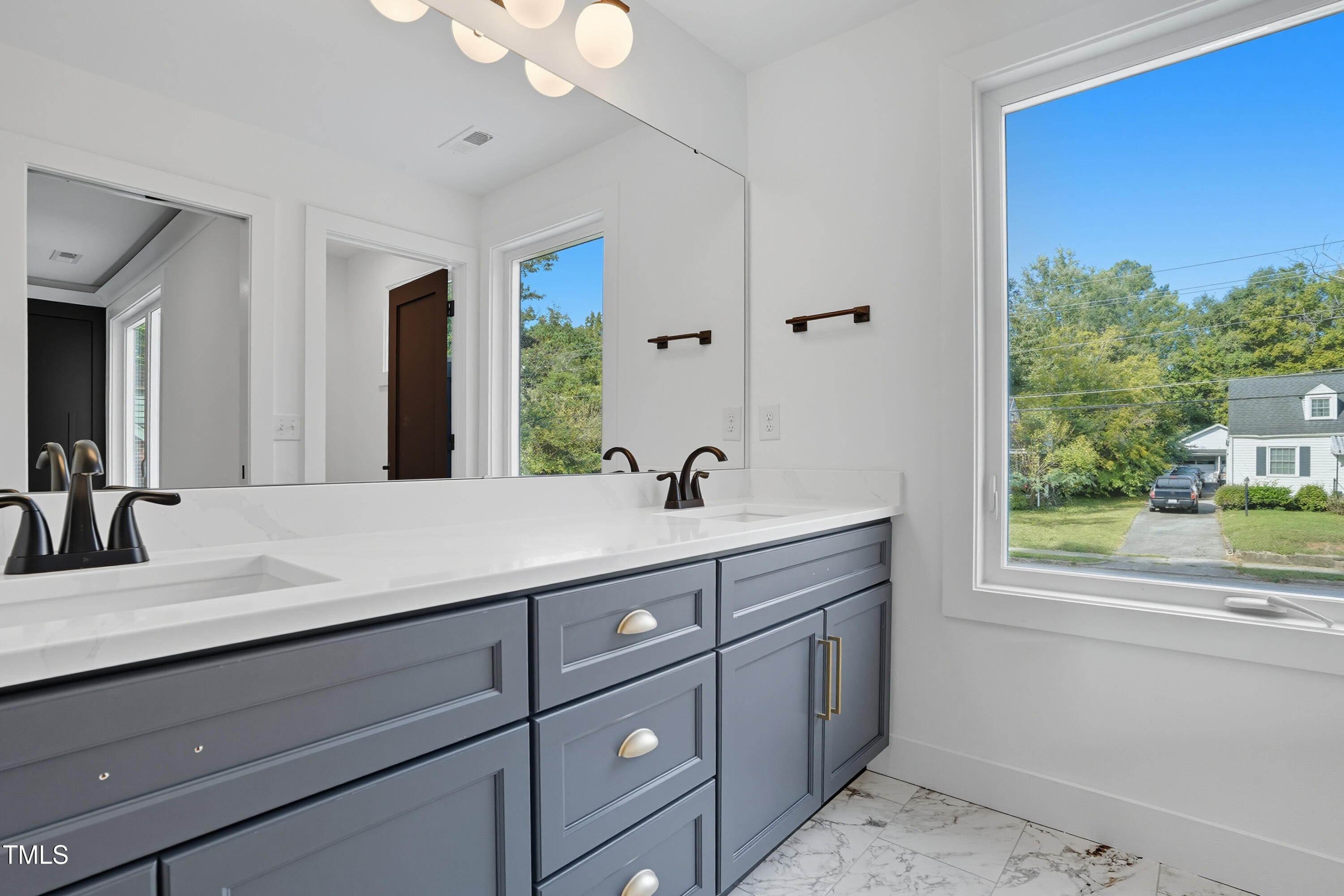 304 North King Charles Road, Unit 102 Raleigh, NC 27610 - Photo 23 of 30 a bathroom with a sink and a mirror