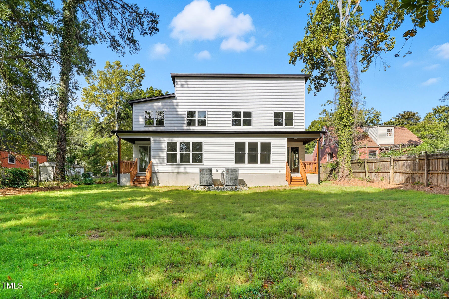 304 North King Charles Road, Unit 102 Raleigh, NC 27610 - Photo 27 of 30 a view of a white house with a big yard and large trees